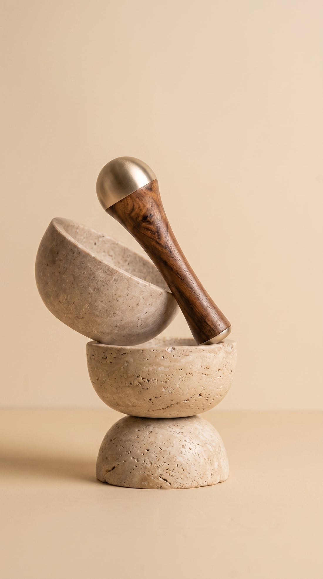 The Herb Garden Kansa Wand — kansa bronze face massage wand with wooden handle on travertine stone bowls